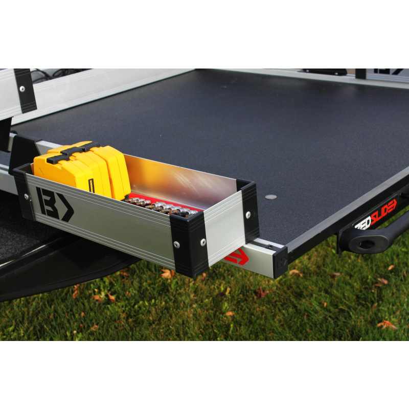 Silver Mini Kix bin loaded with yellow fuel cans alongside an extended BEDSLIDE deck