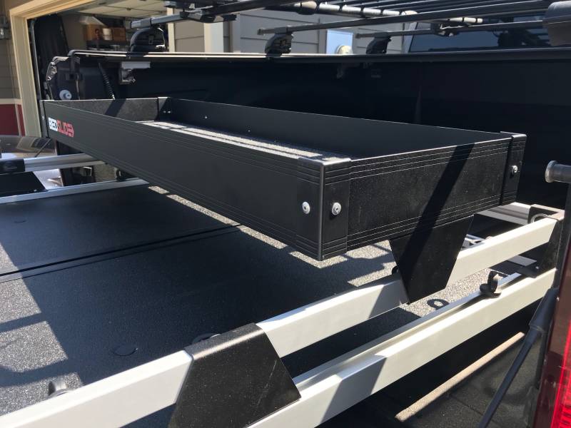 Angled view of the black upper tray mounted above a slide deck, showing the depth of the tray