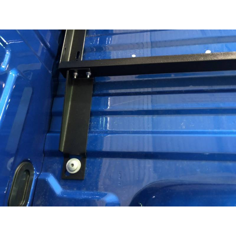 BEDSLIDE no-drill mounting bracket fitted vertically against the side wall of a blue Ford truck bed, bolted at the floor