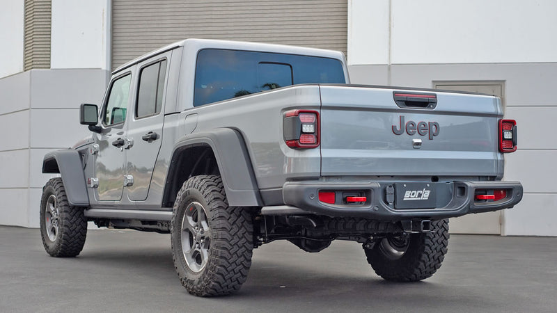 Borla ATAK Cat-Back Exhaust System installed on a Jeep Gladiator: A gray Jeep Gladiator seen from the rear quarter with a Borla plate on the bumper