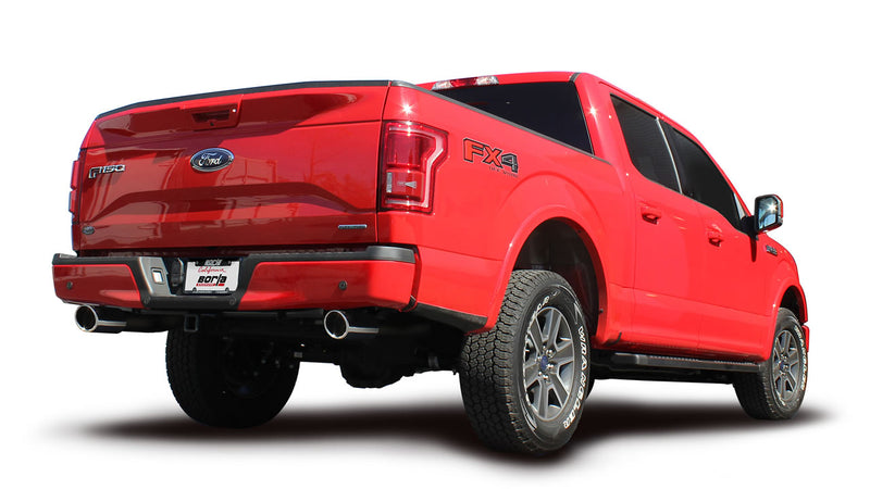Borla ATAK Cat-Back Exhaust System installed on a Ford F-150: A red Ford F-150 FX4 SuperCrew seen from the rear quarter with polished exhaust tips and a Borla plate on the bumper