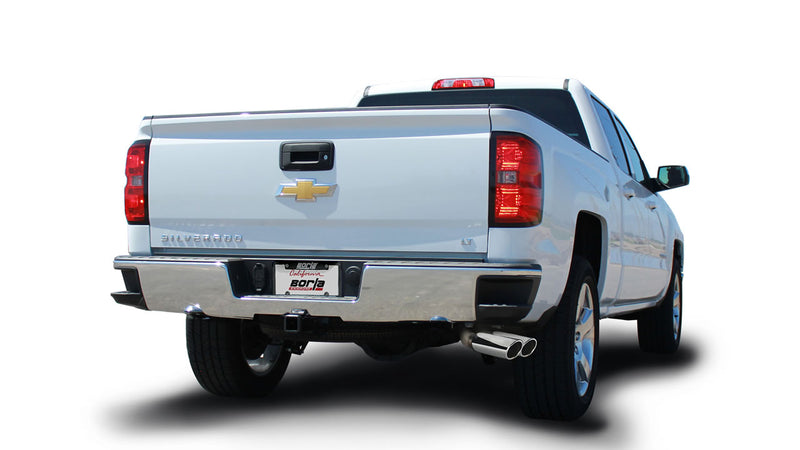 Borla ATAK Cat-Back Exhaust System installed on a Chevrolet Silverado 1500: white Chevrolet Silverado pickup seen from the rear quarter on white with dual polished exhaust tips and a Borla plate