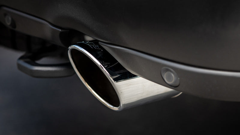 Borla Exhaust Tip Kit: close view of one polished angle-cut exhaust tip installed below a dark vehicle bumper