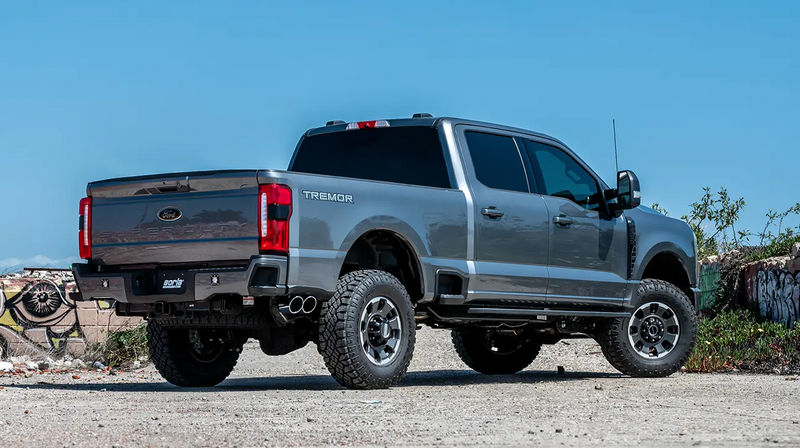 Borla S-Type Cat-Back Exhaust System on a Ford F-250 Super Duty: gray F-250 Super Duty Tremor crew cab rear three-quarter in a lot with Borla plate and dual tips