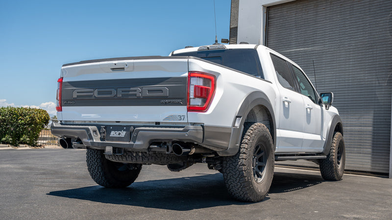 Borla Tail Pipe Kit installed on a Ford F-150 Raptor: A white Ford F-150 Raptor with FORD embossed tailgate shows dark exhaust tips ahead of both rear wheels
