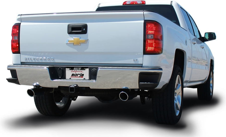 Cat-Back Exhaust Systems by Borla: White Chevrolet Silverado pickup seen from the rear quarter on white with split rear exhaust tips and a Borla plate.