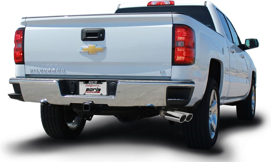 Cat-Back Exhaust Systems by Borla: White Chevrolet Silverado pickup seen from the rear quarter on white with dual polished exhaust tips and a Borla plate.