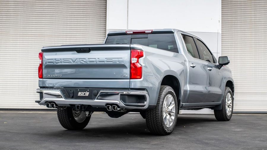 Cat-Back Exhaust Systems by Borla: A gray Chevrolet Silverado 1500 seen from the rear quarter with dual exhaust tips on each side and a Borla plate.