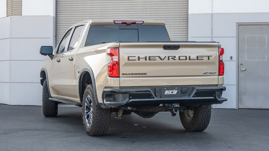 Cat-Back Exhaust Systems by Borla: Tan Chevrolet Silverado ZR2 seen from the rear quarter with exhaust tips below the rear bumper.
