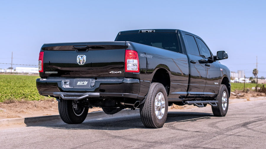 Cat-Back Exhaust Systems by Borla: Black Ram heavy-duty crew cab long bed seen from the rear quarter with a Borla plate and side-exit tip.