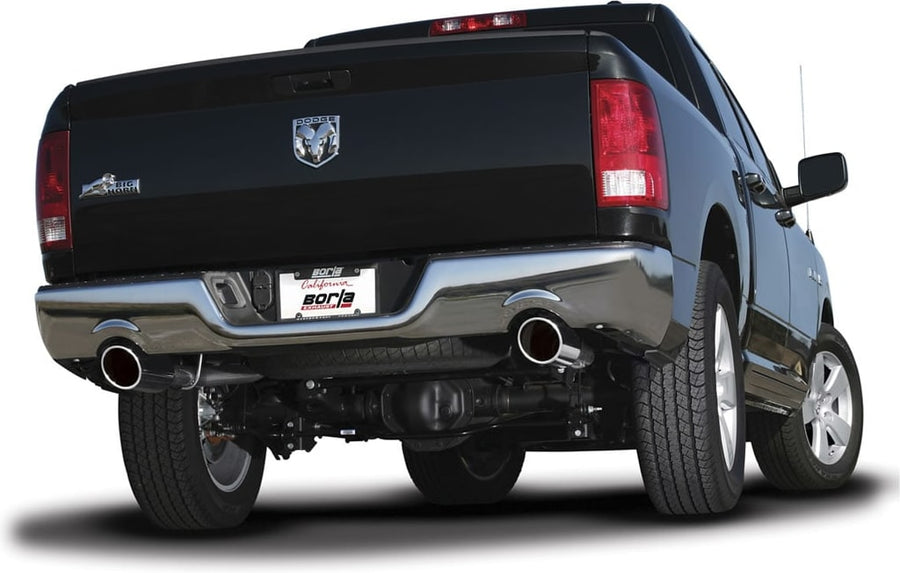 Cat-Back Exhaust Systems by Borla: Rear three-quarter view of a black Ram 1500 on white showing dual polished exhaust tips exiting at each rear corner.