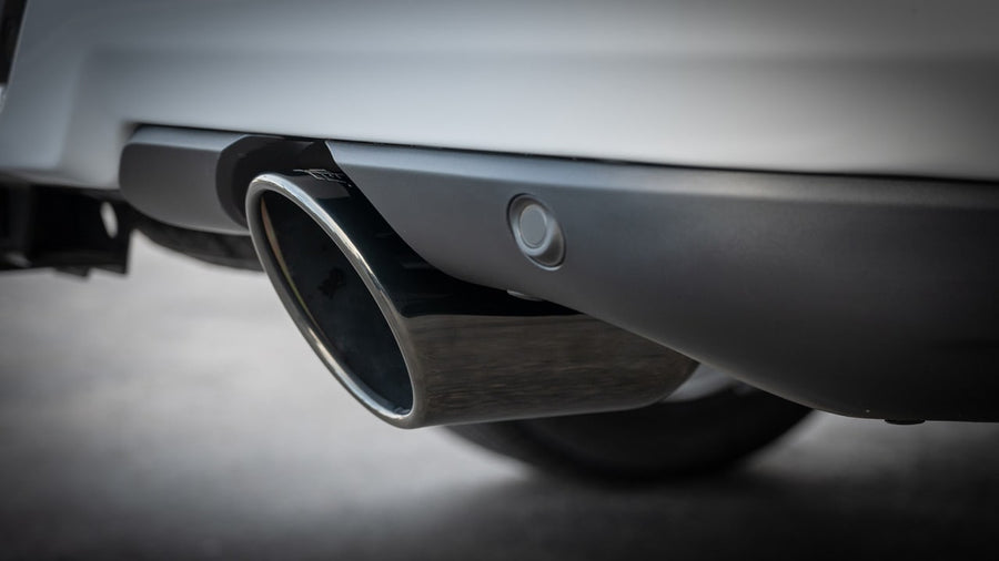 Exhaust Tip Kits by Borla: A black chrome exhaust tip installed below a truck's rear bumper beside a sensor.
