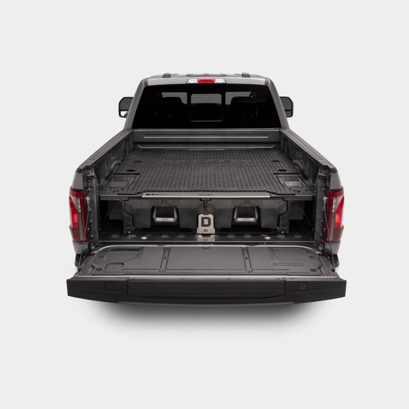 Black DECKED Battle Mat installed on a full-size DECKED Drawer System deck in a pickup bed with the tailgate down