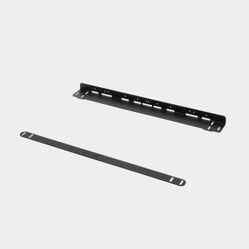 Angled studio view of the two full-length black steel rails in the current DECKED CargoGlide mounting bracket kit