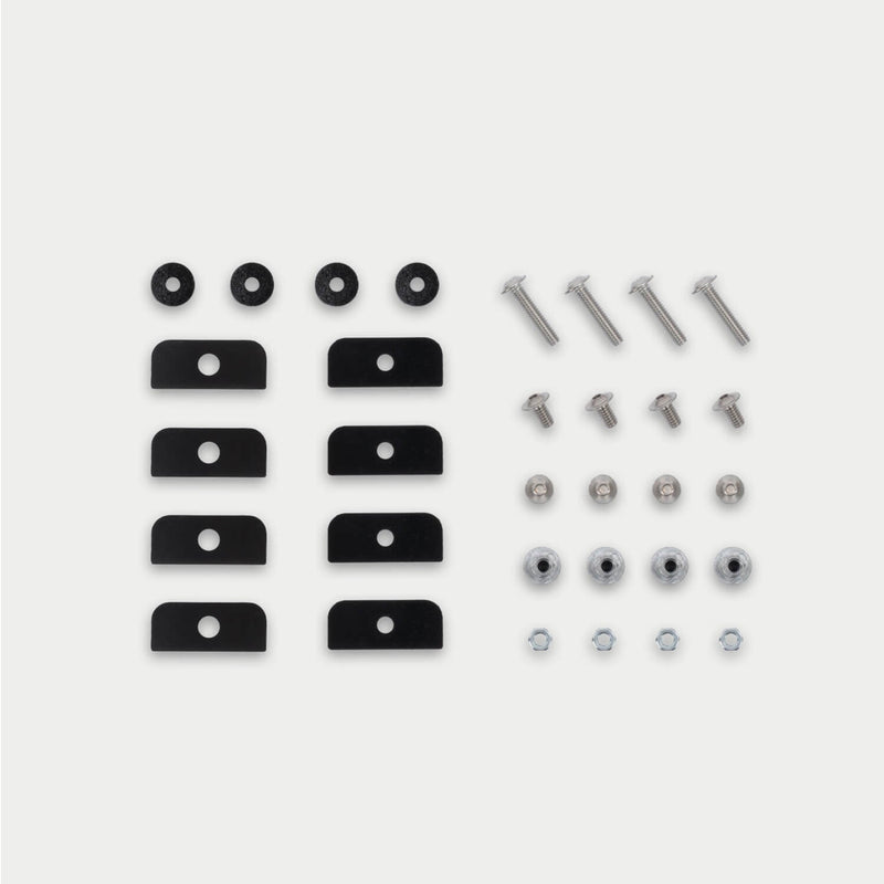 Flat-lay of the DECKED D-co Case Mounting Kit for CargoGlide showing backing plates, foam washers, bolts, threaded inserts and nuts