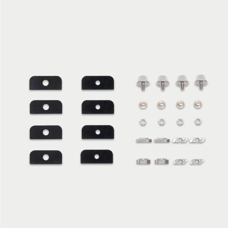 Flat-lay of the DECKED D-co Case Mounting Kit for T-Track showing backing plates, flanged bolts, hex nuts and both styles of M6 T-slot nut