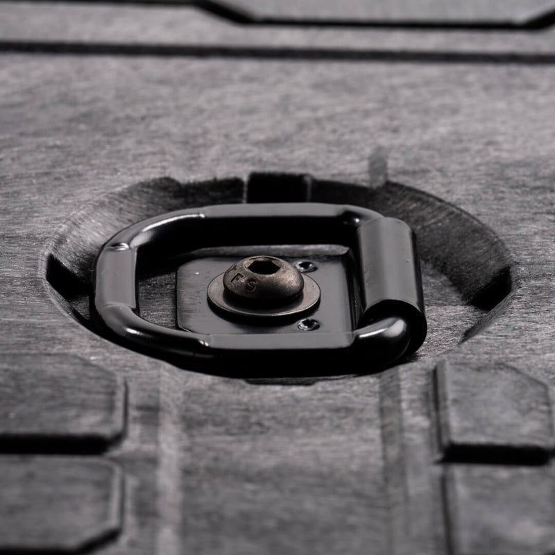 Close-up of a black DECKED D-ring tie down bolted into the recess of a DECKED Drawer System deck, ring lying flat