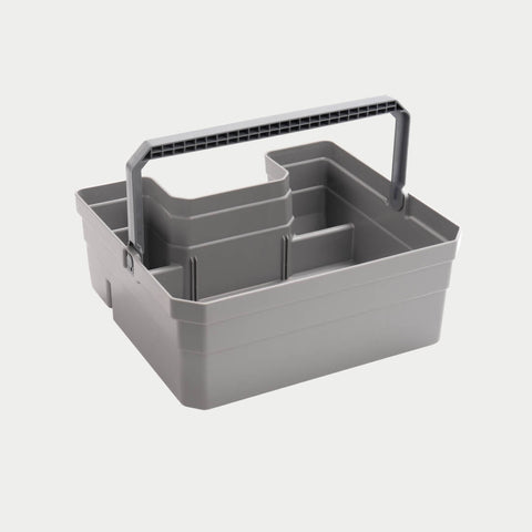 Gray DECKED Double Drawerganizer shown in studio with the molded carry handle raised over the divided compartments
