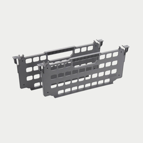 Two gray DECKED drawer dividers shown in studio, perforated panels with hook tabs on each end