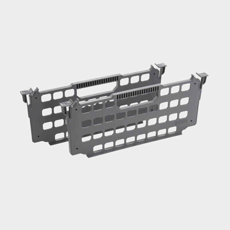 Two gray DECKED drawer dividers shown in studio, perforated panels with hook tabs on each end