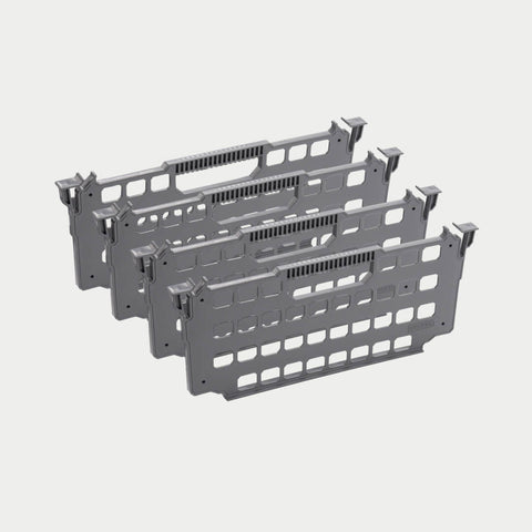Four gray DECKED drawer dividers shown in studio stacked in a row, perforated panels with hook tabs on each end