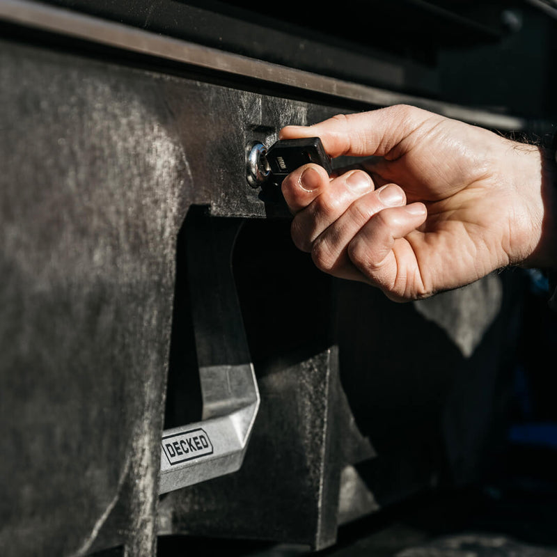 Hand turning a DECKED key in the round drawer lock fitted to the face of a DECKED Drawer System drawer