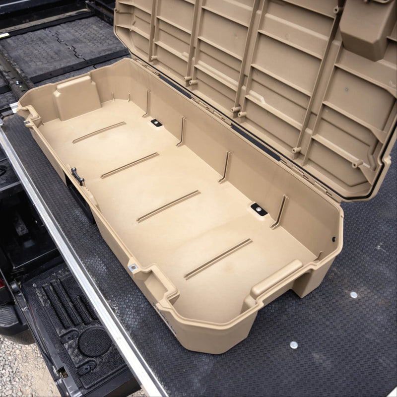 Tan DECKED Honcho 80 case open on a slide-out tray in a truck bed, showing the empty interior and the lid gasket