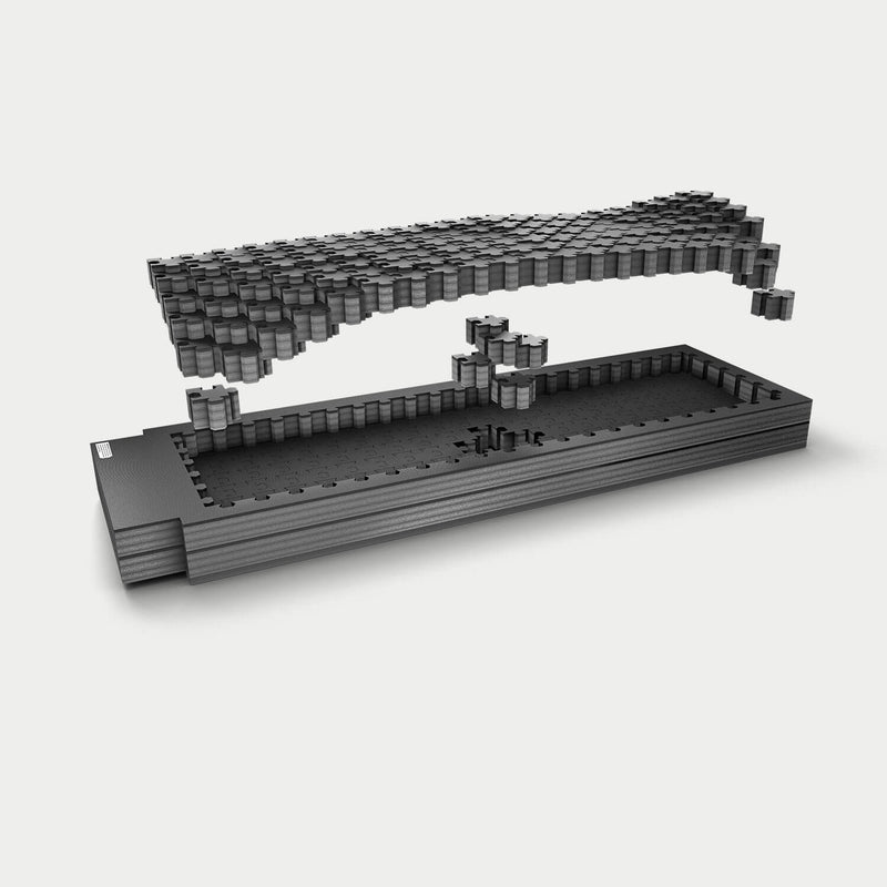 Exploded studio render of the full-size short DECKED Piecekeeper PuzzleFoam showing three stacked rectangular foam layers with the pluck-grid top sheet lifted away