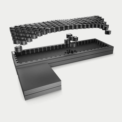 Exploded studio render of the full-size standard DECKED Piecekeeper PuzzleFoam showing three stacked foam layers, the pluck-grid top sheet and the L-shaped side brace