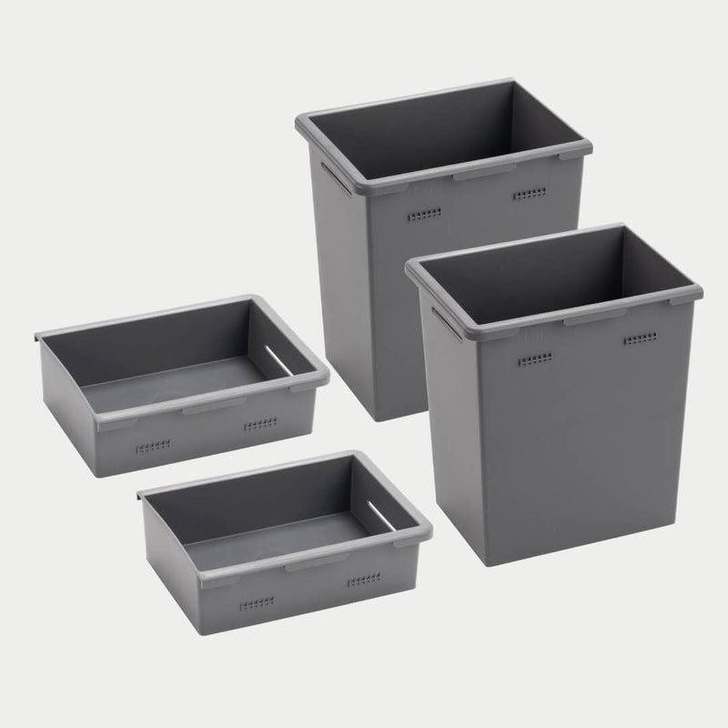 Four gray DECKED Stash Bins shown together in studio, two shallow bins in the foreground and two deep bins behind, for depth comparison