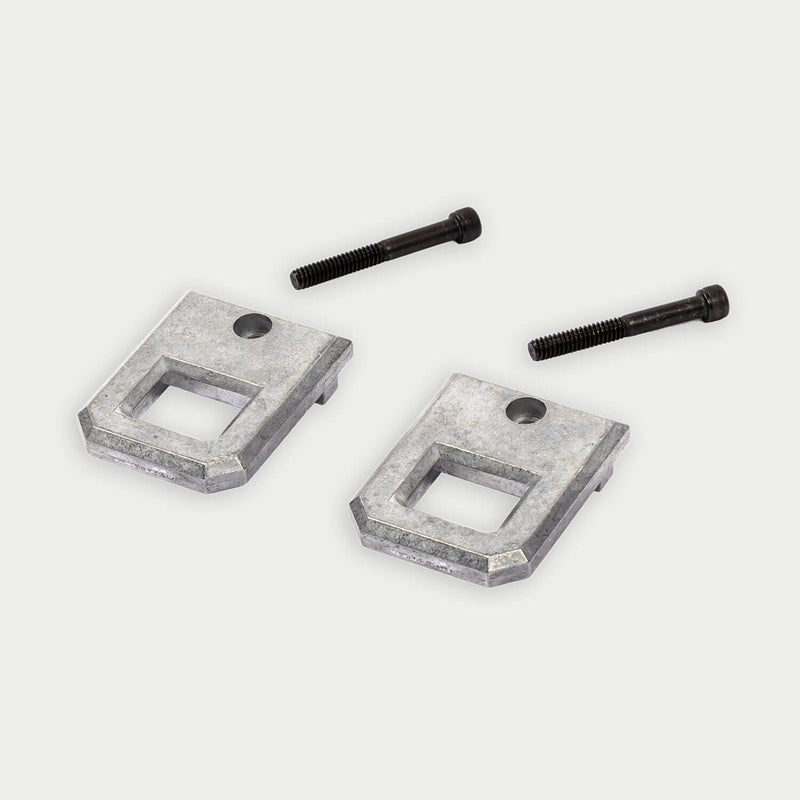 Pair of machined aluminum DECKED Tool Box D-ring tie down anchors shown in studio with two black socket-head bolts