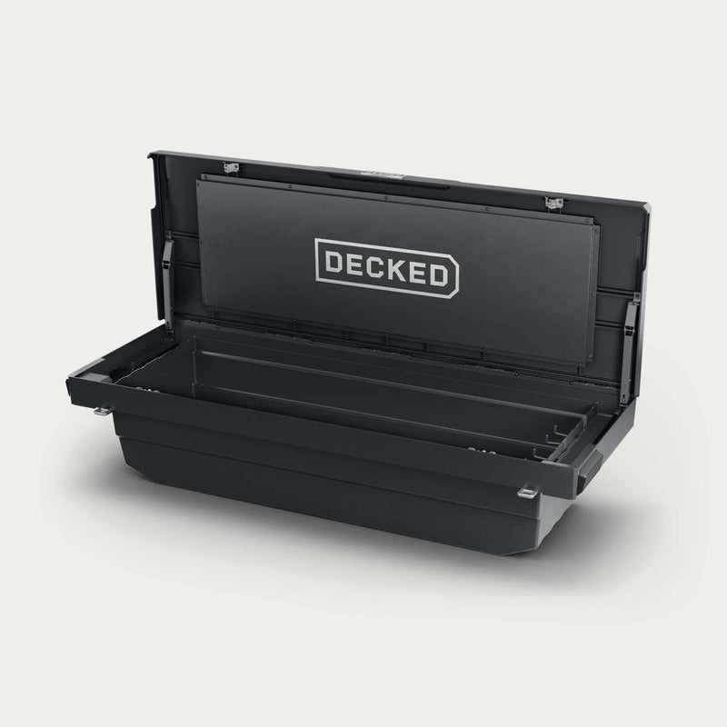 Black DECKED Tool Box DTB2-BLK open in a studio view, showing the full-width tub, gas strut lid assist and the DECKED logo panel inside the lid