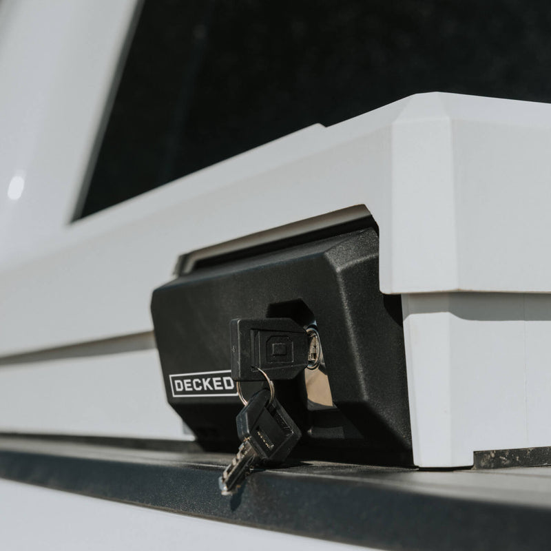 Close-up of the stainless armored lock with keys inserted on the corner of an Industrial White DECKED Tool Box