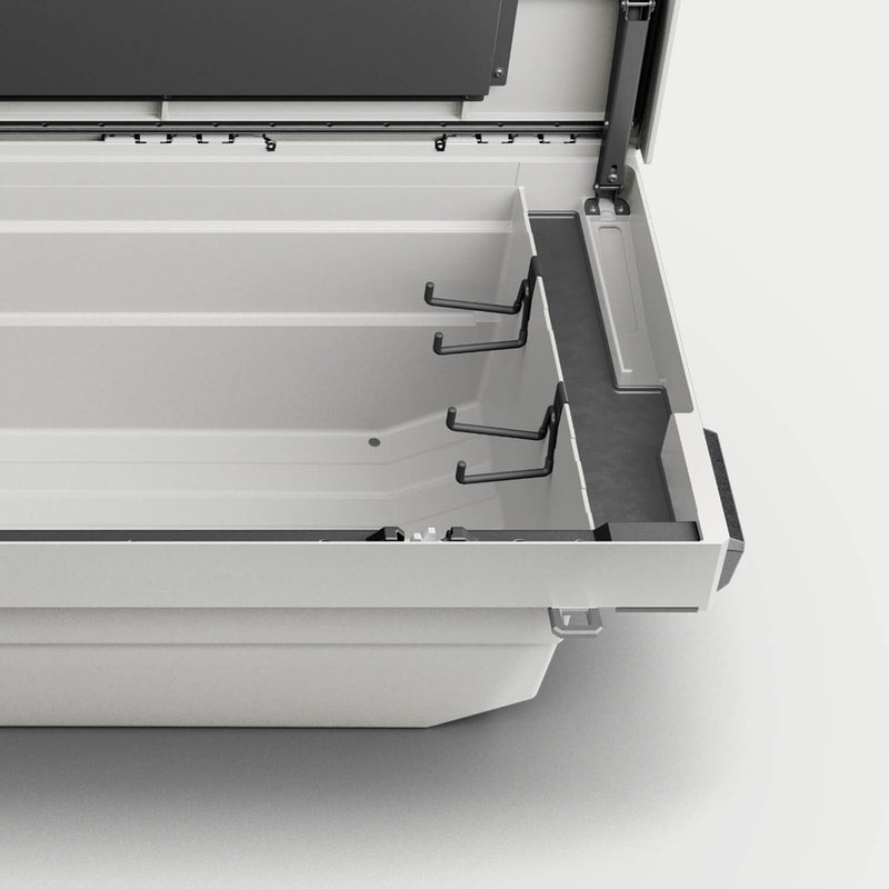 Studio render of a DECKED Tool Box interior with black tool hooks mounted along the tub wall
