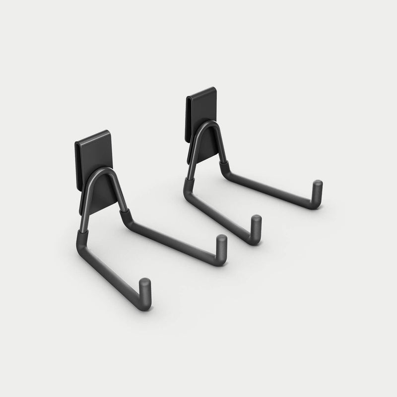 Pair of black DECKED Tool Hooks shown in studio, formed steel hooks on flat mounting clips