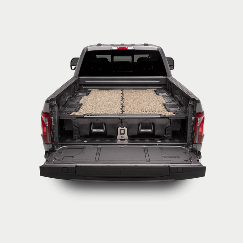 Tan camo DECKED Traction Mat installed on a full-size DECKED Drawer System deck in a pickup bed, tailgate down