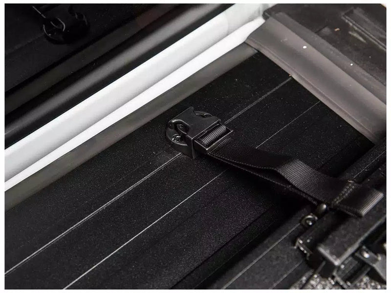 Close-up of an Ultra Flex buckle end and its webbing strap anchored to the panel surface beside the side rail.