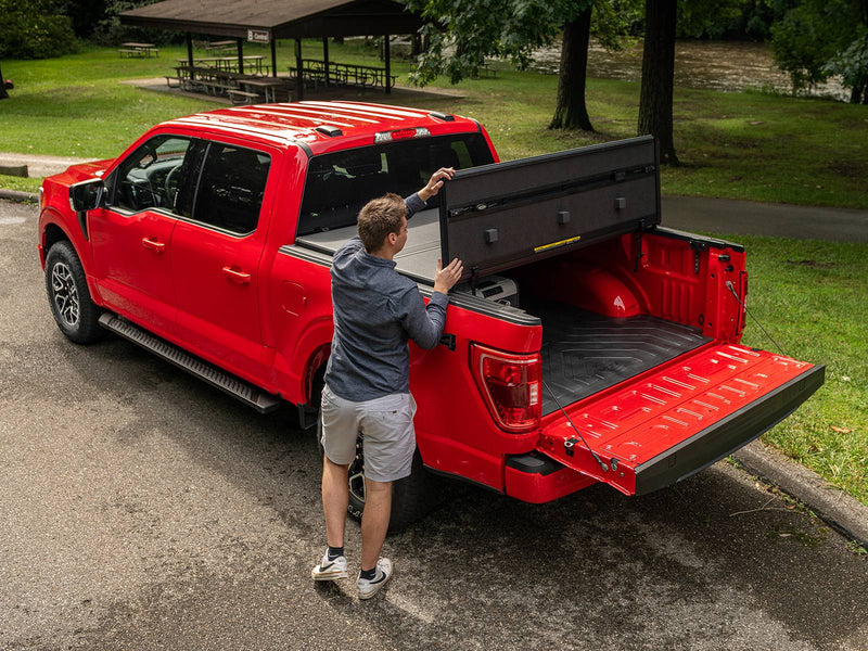 Man raising the folded hard panels with the tailgate down