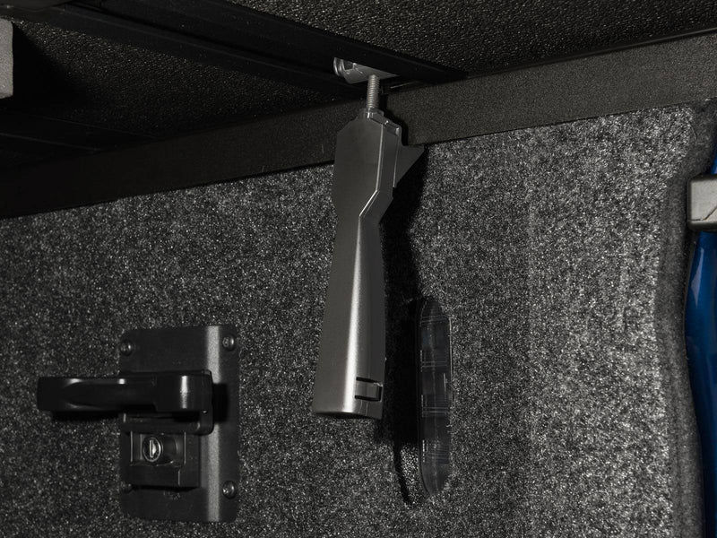 Clamp lever hanging below the side rail beside the bed's tie-down cleat