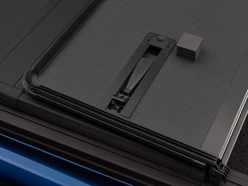 Slide latch and rubber bumper on the hard panel underside next to the edge seal