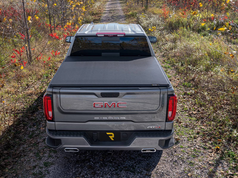 Overhead rear view of a closed soft tonneau cover on a pickup in a field