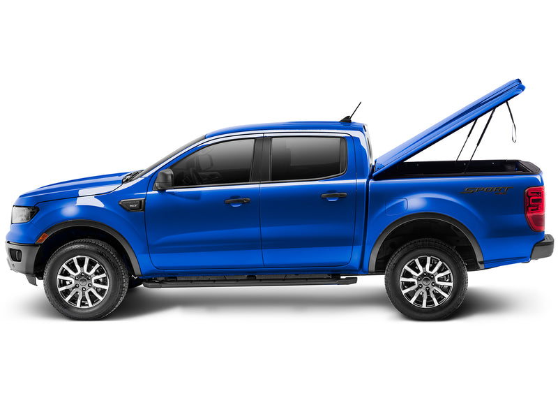 UnderCover Elite LX one-piece tonneau cover raised on its gas struts, full side profile, showing how high the lid stands and how far back it clears the box.