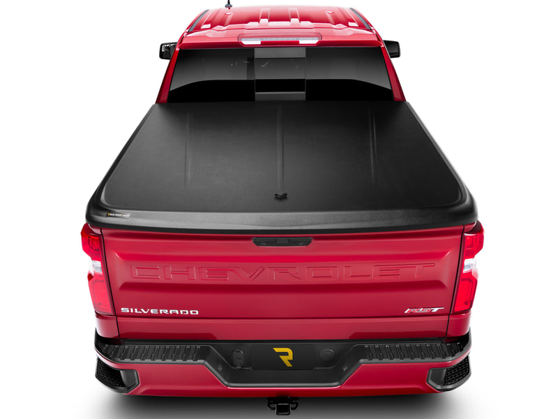 UnderCover SE one-piece tonneau cover closed and latched, straight rear view with the whole lid square to the camera and both bed rails covered.