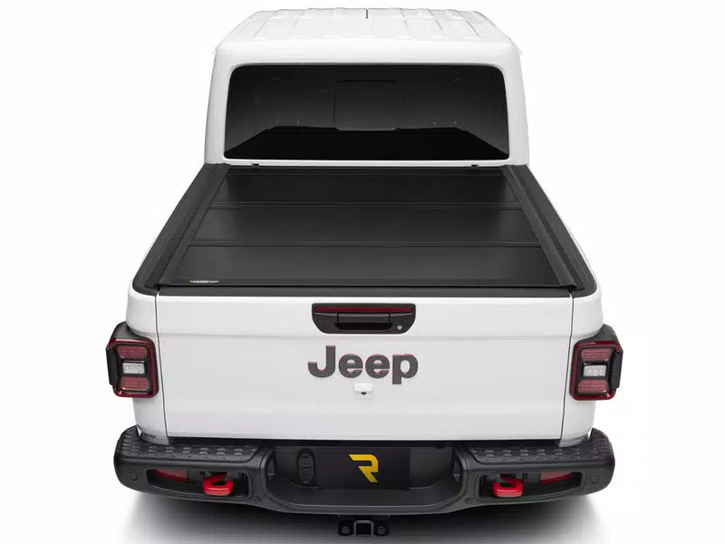 UnderCover Ultra Flex hard folding tonneau cover closed and flush across the full bed width, straight rear view.