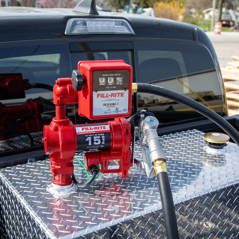 Fill-Rite FR1211H 12V DC 15 GPM Fuel Transfer Pump with Meter & Nozzle, mounted on a diamond-plate transfer tank in a pickup bed