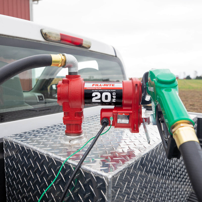 Fill-Rite FR4210HD 12V DC 20 GPM Fuel Transfer Pump with Nozzle, mounted on a diamond-plate transfer tank in a pickup bed
