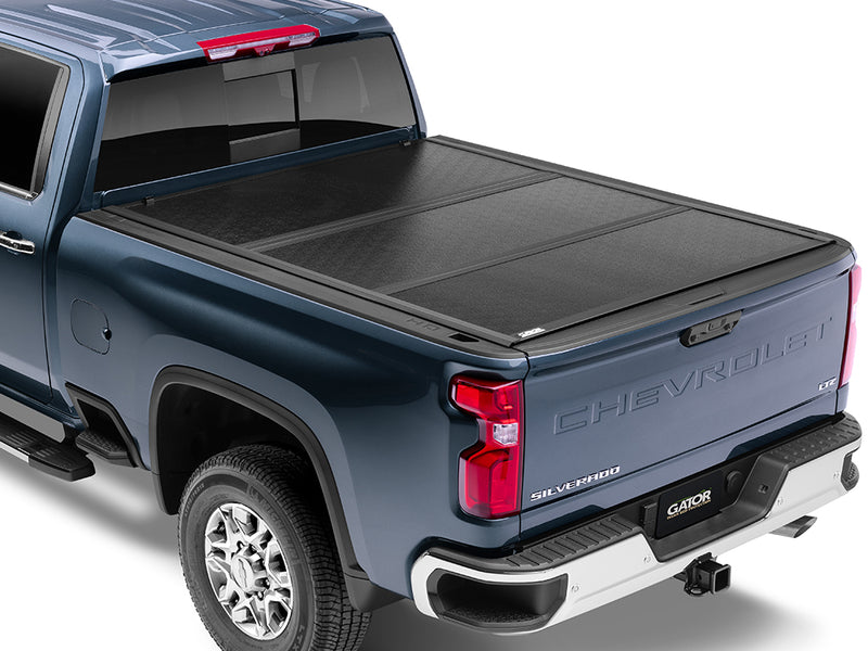 Gator EFX hard folding tonneau cover: A blue Chevrolet Silverado heavy duty with a closed black hard folding cover