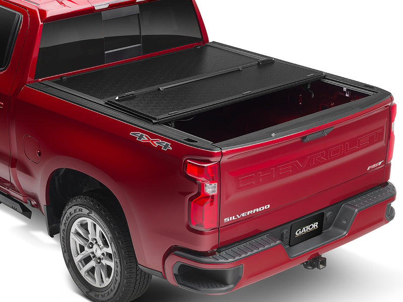 Gator EFX hard folding tonneau cover: A red Chevrolet Silverado with its hard folding cover partly folded
