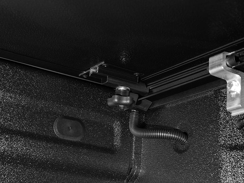 Gator EFX hard folding tonneau cover: Close-up of the clamp and drain tube under the cover rail