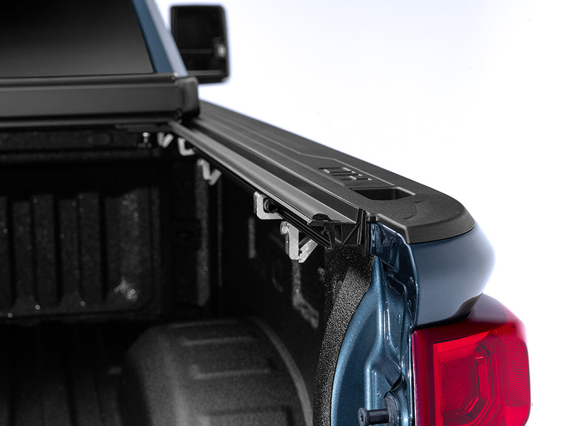 Gator EFX hard folding tonneau cover: Close-up of the cover rail along the bed side of a blue pickup with the bed open